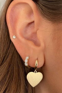 model wearing 3 Diamond Huggies 14k gold
