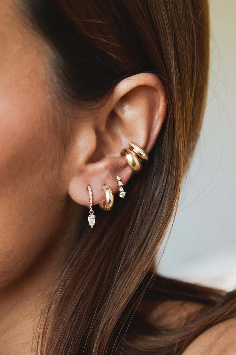 model wearing 5 Diamond Chubby Huggie Hoops earrings 14k gold