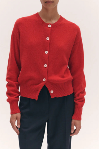 front profile model wearing Ada Crew Neck Cardigan Poppy Red  lambswool relaxed fit