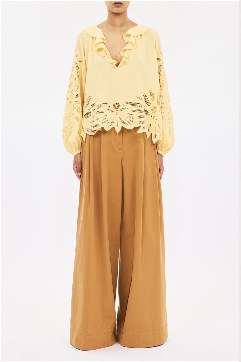 front profile model wearing  Adonis Silk Top dandellion yellow Botanical embroidery
Silk crepe de chine
Relaxed fit
V-neckline with ruffles long sleeves with elastic cuffs
Pullover style