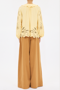 back profile model wearing  Adonis Silk Top dandellion yellow Botanical embroidery
Silk crepe de chine
Relaxed fit
V-neckline with ruffles long sleeves with elastic cuffs
Pullover style
