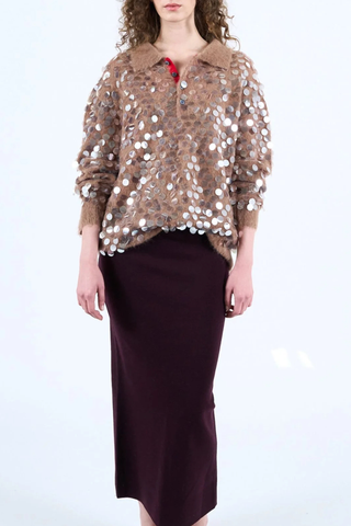 front profile model wearing Adora Long sleeve Pailette polo camel with red contrast on collar button area