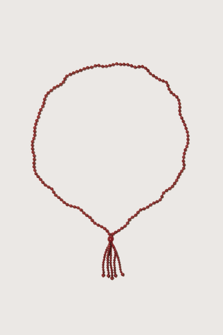flat lay Agate Tassel Necklace Round red agate beads
Softly draped tassel
Can be worn long or layered to add contrast and texture to everyday dressing
Necklace length 80cm. Tassel length 10cm