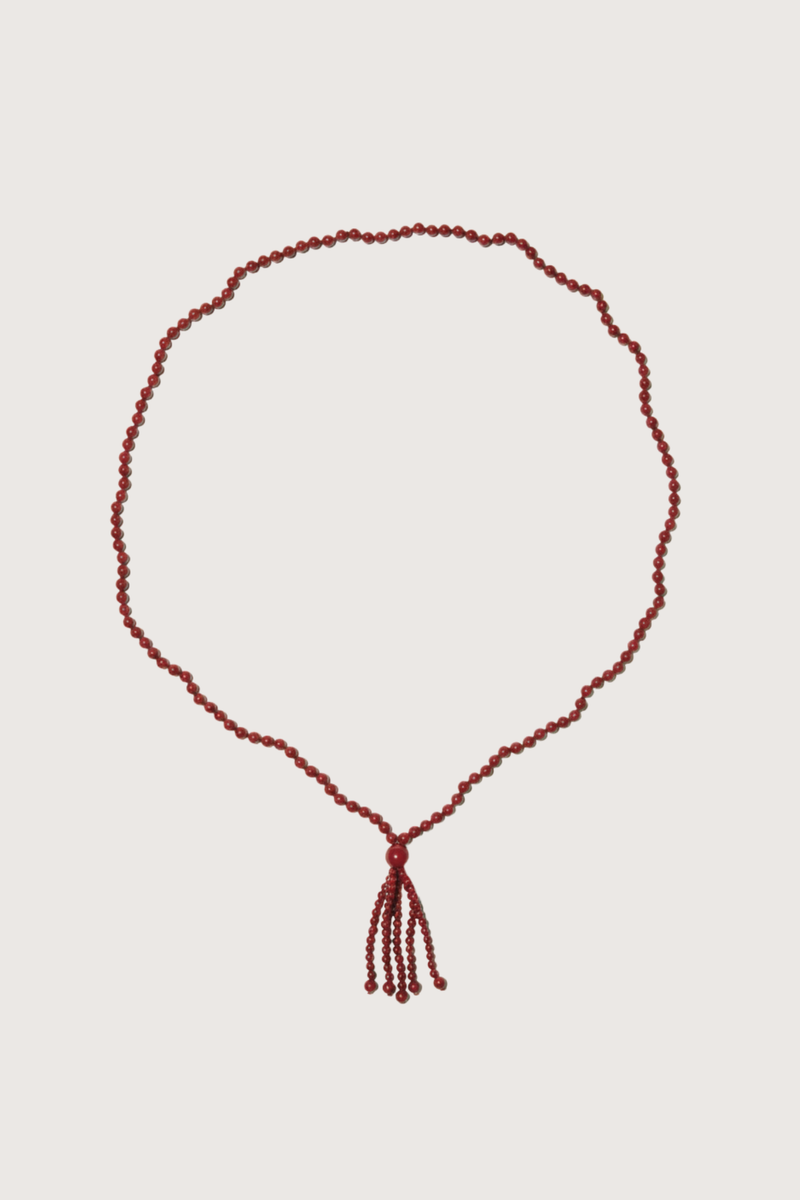 flat lay Agate Tassel Necklace Round red agate beads
Softly draped tassel
Can be worn long or layered to add contrast and texture to everyday dressing
Necklace length 80cm. Tassel length 10cm