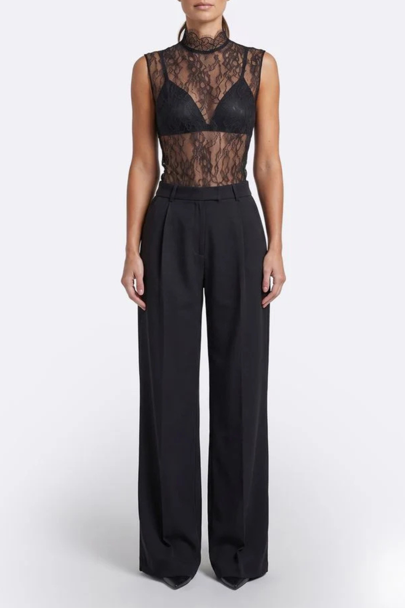 front profile model wearing Alexis Mid Rise Trouser Black Mid-rise waist
Relaxed wide-leg
Front pleats
Hidden hook-and-clasp closure
100% Polyester
