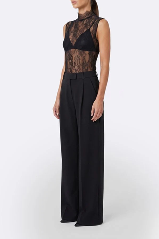 side profile model wearing Alexis Mid Rise Trouser Black Mid-rise waist
Relaxed wide-leg
Front pleats
Hidden hook-and-clasp closure
100% Polyester