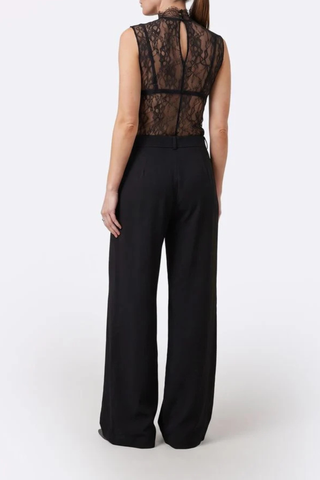 back profile model wearing Alexis Mid Rise Trouser Black Mid-rise waist
Relaxed wide-leg
Front pleats
Hidden hook-and-clasp closure
100% Polyester
