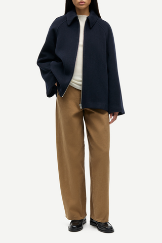 front profile model wearing Alma Wool Blend Zip Front Jacket navy blue pointed collar relaxed fit raglan sleeves unzipped