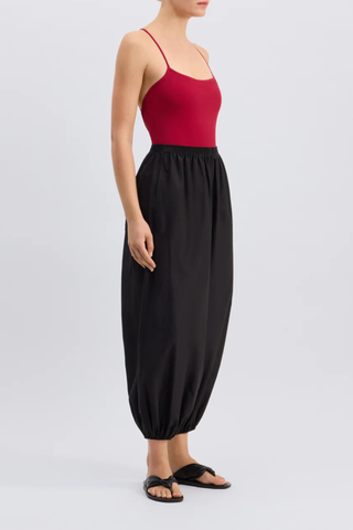 side profile model wearing Almaya Balloon Pant Black Balloon trousers
Mid-rise fit
Wide leg gathered at the ankles
Cocoon-like silhouette
Side seam pockets
Elasticated waistband
65% Cotton, 35% Silk Voile