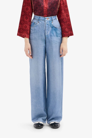 front profile model wearing Aloe Silk Pants light blue  Mimic the casual attitude of denim with the refined fluidity of silk