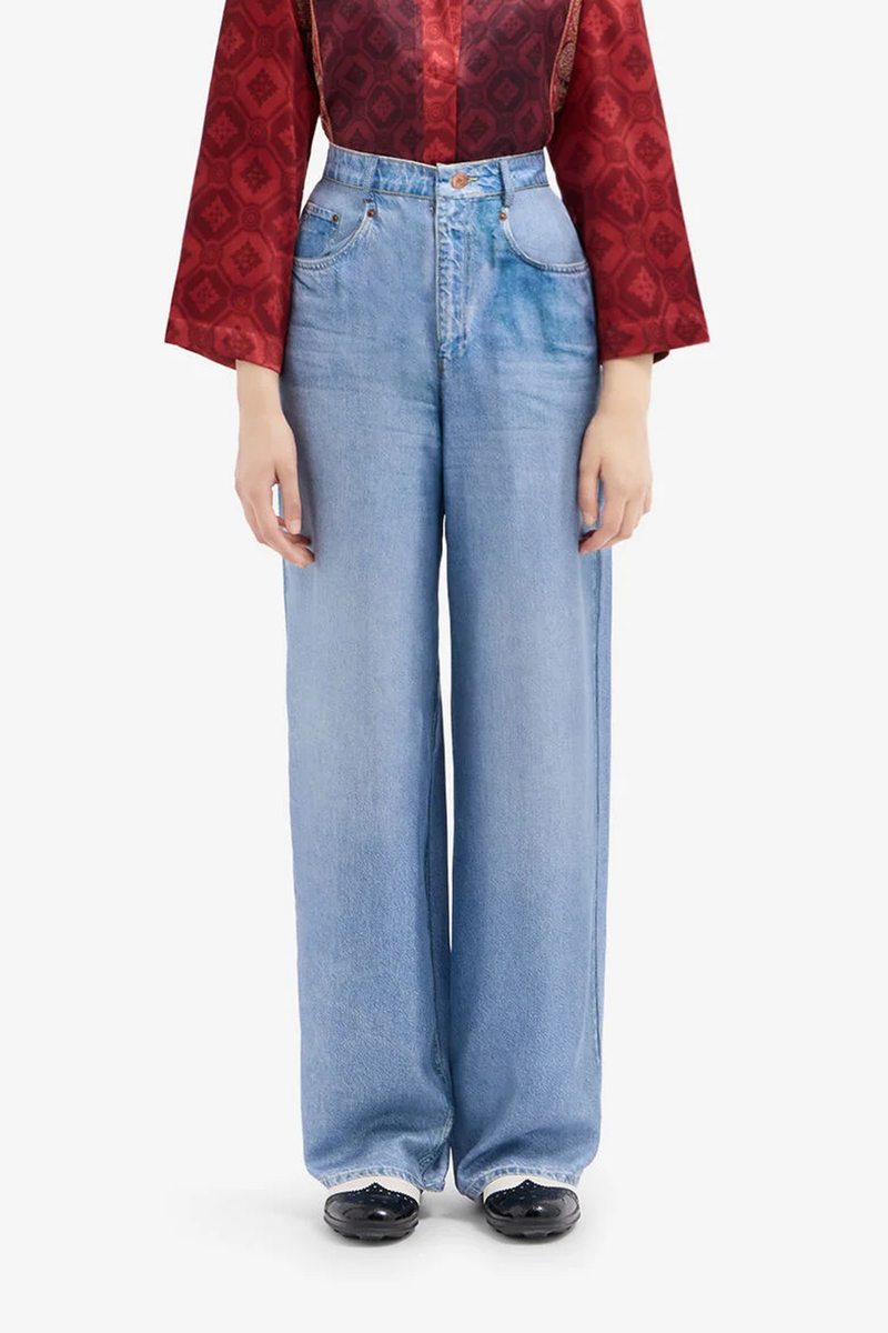 front profile model wearing Aloe Silk Pants light blue  Mimic the casual attitude of denim with the refined fluidity of silk