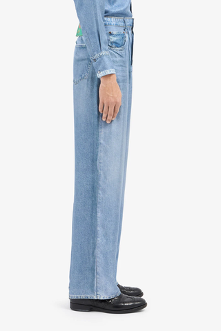 side profile model wearing Aloe Silk Pants light blue  Mimic the casual attitude of denim with the refined fluidity of silk