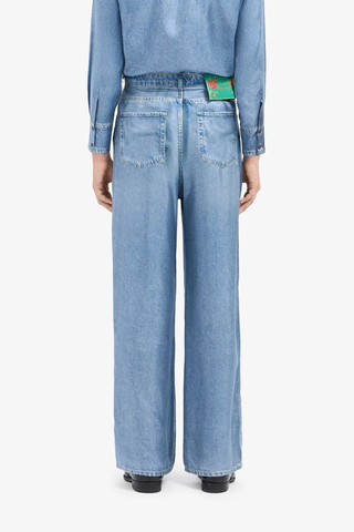 back profile model wearing Aloe Silk Pants light blue  Mimic the casual attitude of denim with the refined fluidity of silk