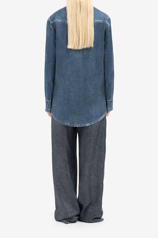 back profile model wearing Aloe Silk Shirt Medium Blue Silk shirt with denim effect reimagines a western classic with refined tailoring