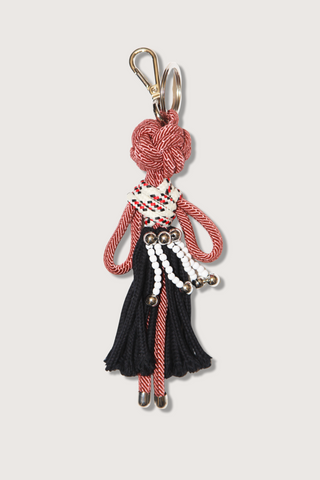 flat lay Amaru Key Ring charm Macramé  of doll design red and black