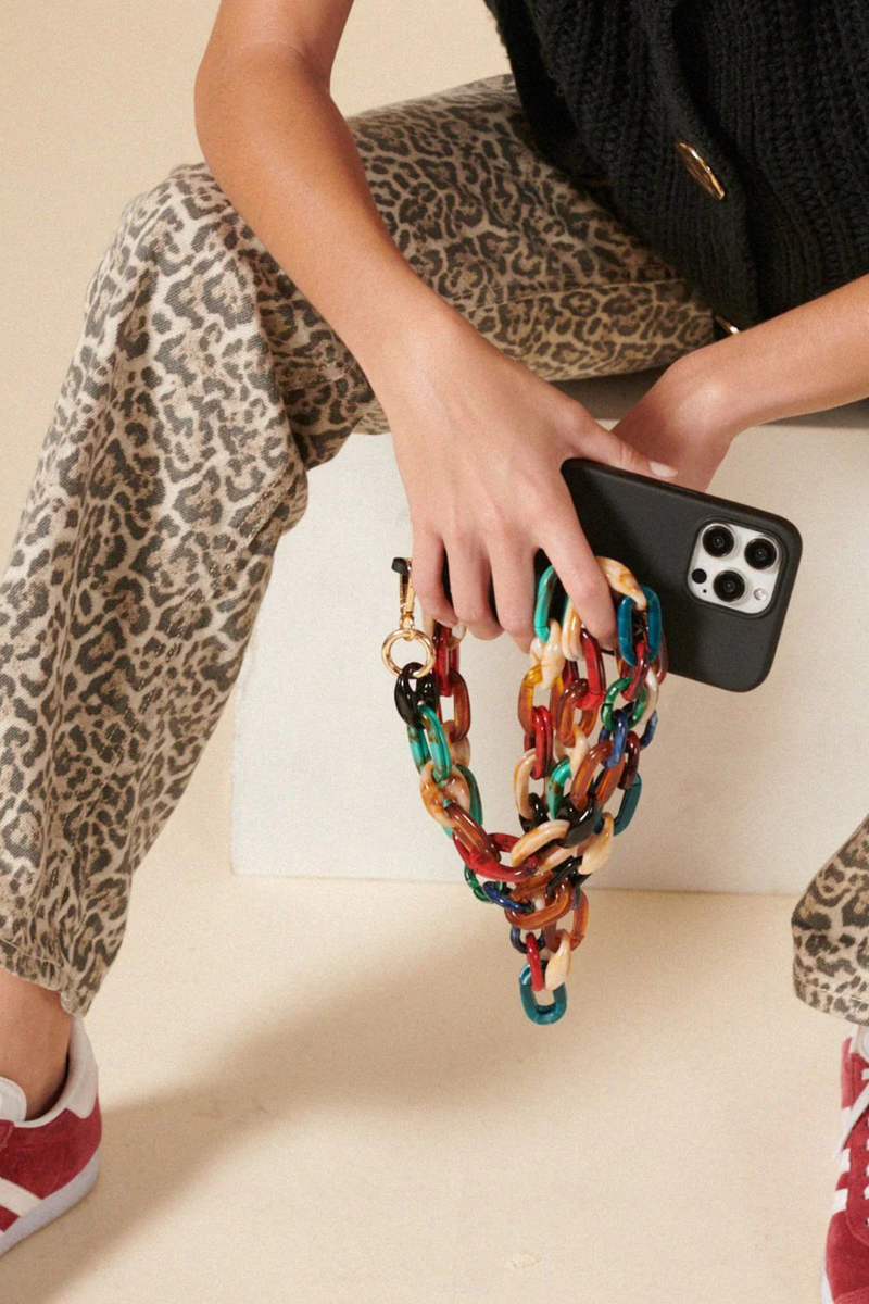 model wearing Amber Short Chain For Phone Multi-colored chain with gold carabiners iphone strap