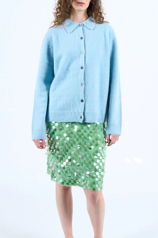 front profile model wearing Andrew Button Down Merino/Cashmere blue long sleeve cardigan shirt blue front white back colorblock