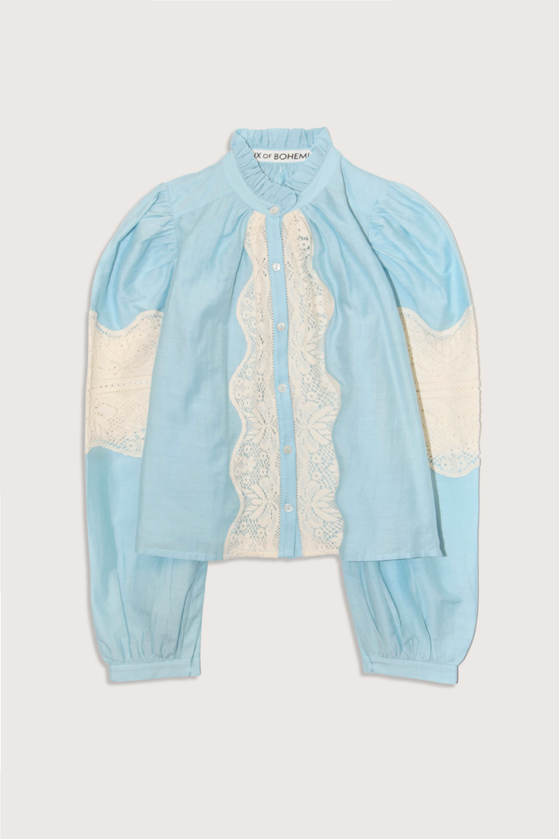 flat lay Annabel Sky Prima Lace Shirt light blue  Cotton silk blend
Ruffle collar
Subtle puff shoulders
Lace detail throughout
Relaxed fit
long sleeve
button down