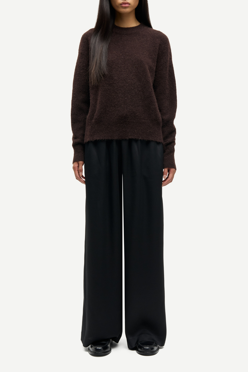 front profile model wearing Anour O-N Sweater Black Coffee brown crewneck regular fit  dropped shoulders Rib-knitted crewneck collar, cuffs, and hem