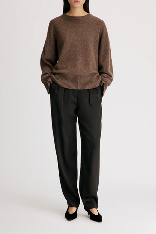 front profile model wearing Anton Crew Cashmere Sweater Coffee brown Slightly oval fit
Enveloping, effortless silhouette
Crew neck
Drop shoulders
Ribbed details
Vented cuffs
100% Cashmere