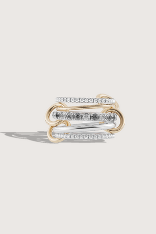 flat lay Aquarius SG Grisring. 4 bands mix of 925 sterling silver/ 18k yellow gold/sterling silver band
Stones: Gray and white diamonds
4 Connectors: 18k yellow gold