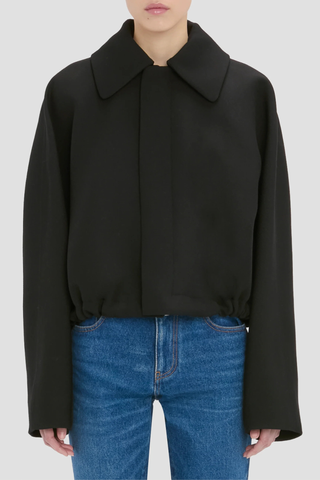 front profile model wearing Arden Bomber Jacket black oversized fit Soft heavy gabardine
Hip length style with an oversized shoulder
Zip and Popper fastening
Side pockets and adjustable tied hem
100% Virgin Wool