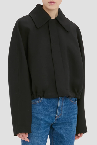side profile model wearing Arden Bomber Jacket black oversized fit Soft heavy gabardine
Hip length style with an oversized shoulder
Zip and Popper fastening
Side pockets and adjustable tied hem
100% Virgin Wool