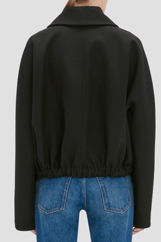 back profile model wearing Arden Bomber Jacket black oversized fit Soft heavy gabardine
Hip length style with an oversized shoulder
Zip and Popper fastening
Side pockets and adjustable tied hem
100% Virgin Wool
