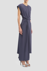 side profile model wearing Aria Twist Waist Dress eclipse muted blue grey Ankle length with asymmetric hem
Drape fabrication
Round front neckline
V-shape back
Cap sleeve
Twist waist
Concealed zip with hook &amp; eye closure
