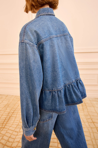 back profile model wearing Arquette Denim Jacket Danube blue denim
Non-stretch denim
peplum hem design
Designed for a boxy fit
Oversized patch pockets
Signature monogram buttons through front