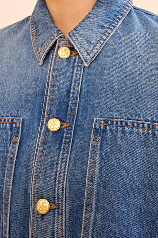 close up button detail for Arquette Denim Jacket Danube blue denim
Non-stretch denim
peplum hem design
Designed for a boxy fit
Oversized patch pockets
Signature monogram buttons through front