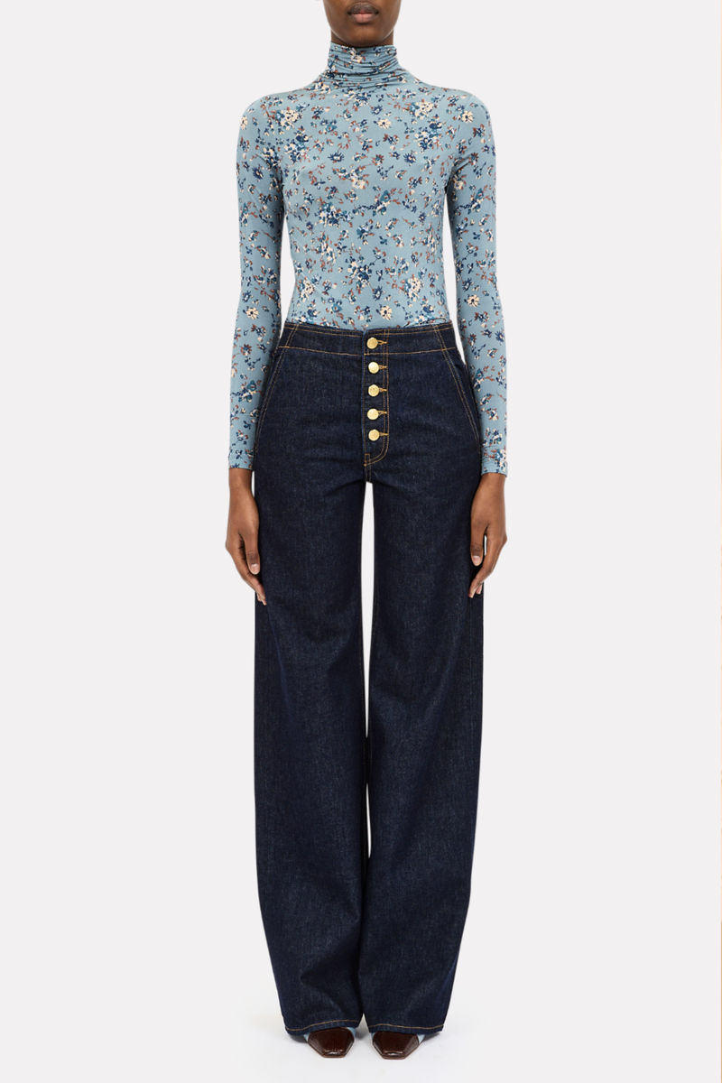 front profile model wearing Aurelia Long Sleeve Turtle Neck Celeste blue with floral prints Turtleneck
Lightweight tricot jersey
bold, swirling ikat motifs based on a vintage print
&nbsp;Long-sleeve
Close slim fit
91% Rayon, 9% Elastane