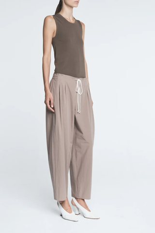 side profile model wearing Balloon Drawstring Trouser Mouseback 
Tapered bottom
organic washed cotton
Loose drawstring trousers
Side pocketing
front pleats