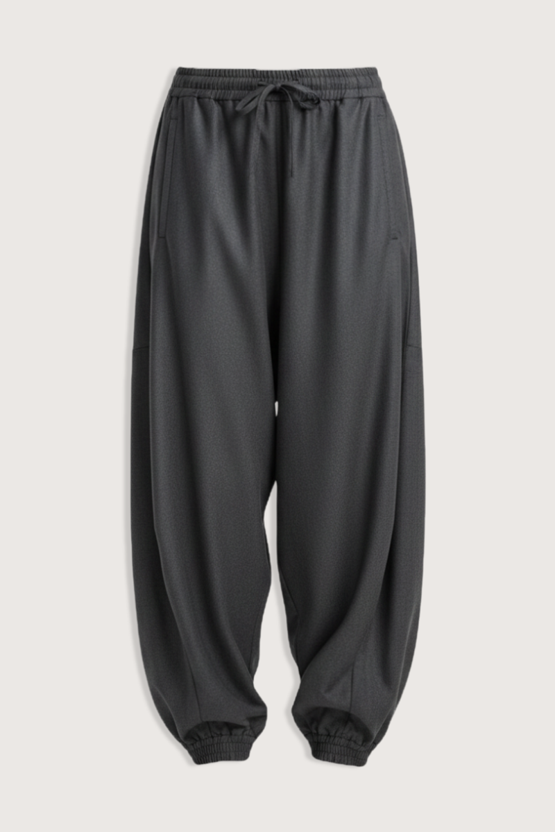 flat lay Balloon Track Wool Pant dark grey melange Balloon track pants
Soft dark grey wool
Elasticated waistband and hem
Voluminous leg
Front welt pockets
100% wool