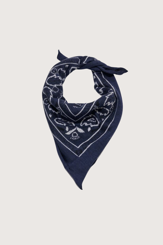 flat lay Bandana Cashmere Scarf Navy  100% cashmere
Bandana print
Hand-knit construction
27" Width x 24" Length tied up