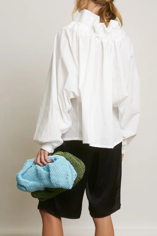back profile model wearing Beautiful Mess Top Cloud white Bow neck
puff sleeves
Grand ruffle neck cinched in with lovely wide ribbon
Long sleeve
Elastic cuff
Straight hem
100% Cotton