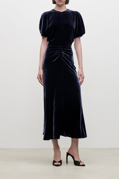 front profile model wearing  Bela Silk Velvet Dress navy Midi-length
Silk viscose velvet

Soft, fluid drape
Mid weight piled velvet
Round front neckline
V-shaped back
Front waist gather
82% Viscose 18% Silk