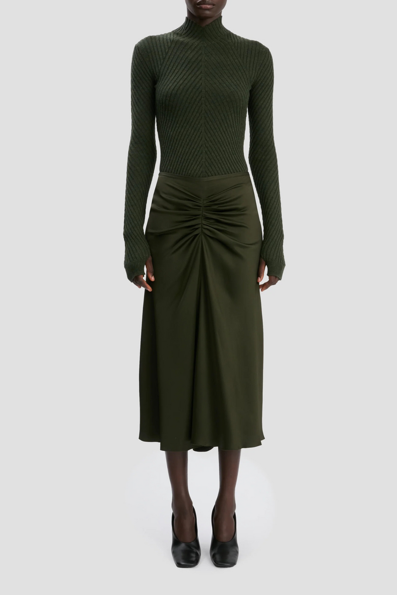 front profile model wearing  Bella Skirt dark olive green midi length gathered waist flared hem
