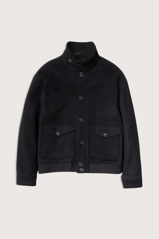 flat lay Belleville Bomber black Ribbed hem and collar
Patch pockets with buttons and side entry
Buttons at front and cuffs. Two internal pockets
Fully lined
100% Virgin Wool
