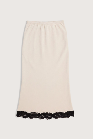 flat lay Bias Skirt champagne
Matte sateen
 black floral lace trim
Cotton corded lace
Cut on the bias
Delicate lingerie stitch elastic waistband
Knee-length
100% Naia acetate