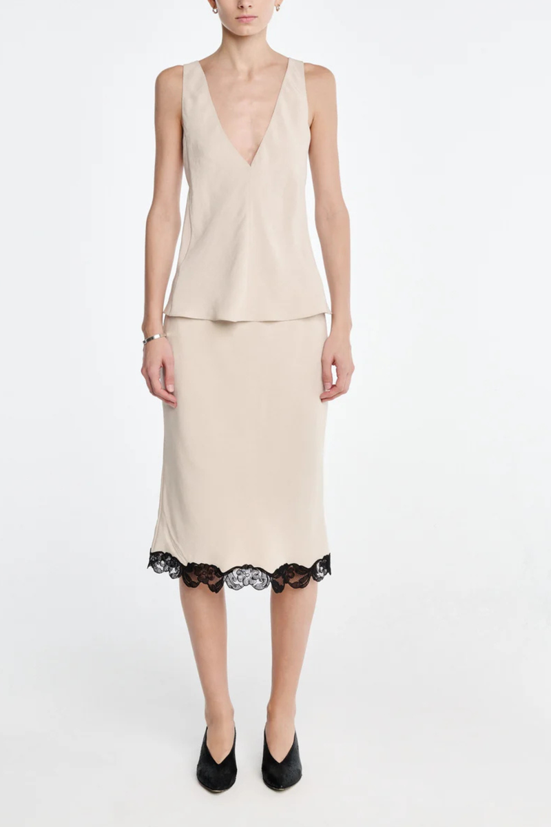 front profile model wearing Bias Skirt champagne
Matte sateen
 black floral lace trim
Cotton corded lace
Cut on the bias
Delicate lingerie stitch elastic waistband
Knee-length
100% Naia acetate
