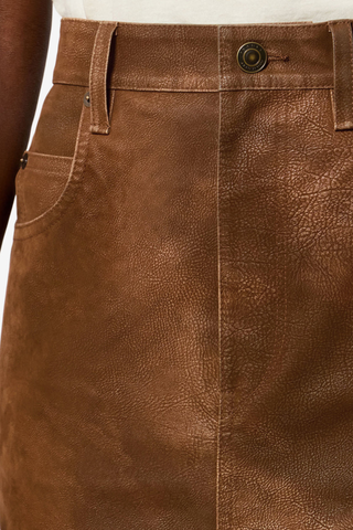 close up texture detail and front button detail with logo for Bisane Pencil Faux Suede Skirt brown Faux suede midi skirt with a distressed finish
Mid-rise
Front closure with hidden zip fly 
Waistband with belt loops
Front slit
Embossed "Isabel Marant" leather patch at the back
Polyester 100%