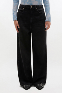 front profile model wearing Black Washed Baggy Jeans Zip and button closure 5 pockets Belt loops GANNI logo at the back pocket
