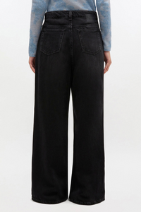 back profile model wearing Black Washed Baggy Jeans Zip and button closure 5 pockets Belt loops GANNI logo at the back pocket