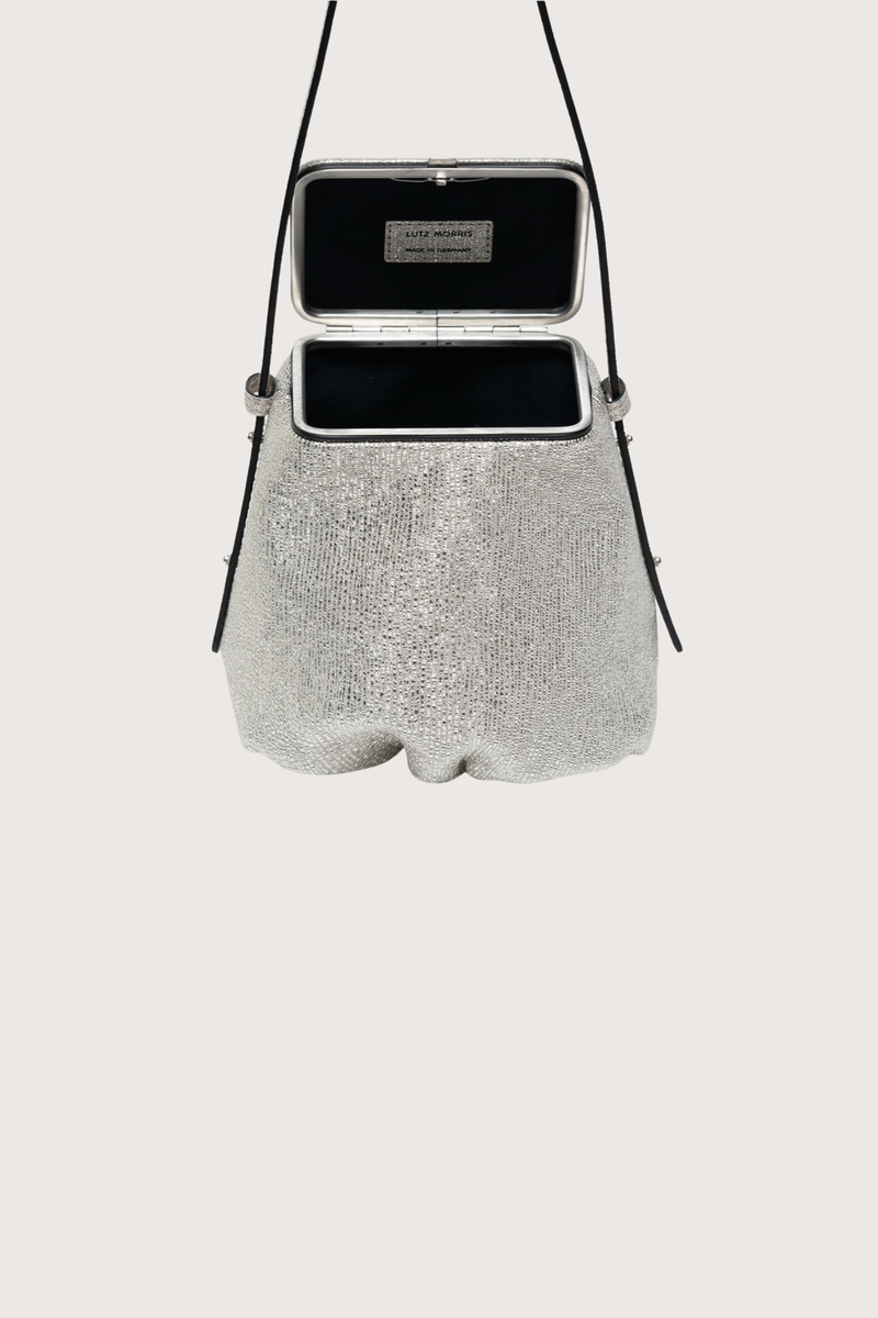 open detail Blaine Short Strap Bag Silver Metallic Pouch style bag
Single latch closure
Voluminous pleated pouch
Adjustable strap in nappa leather
Italian suede with applied mini-dots
24k gold-plated hardware
