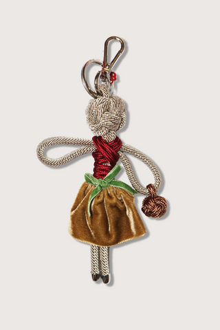 flat lay Blanche Key Ring charm Macramé of a doll design beige and burgundy