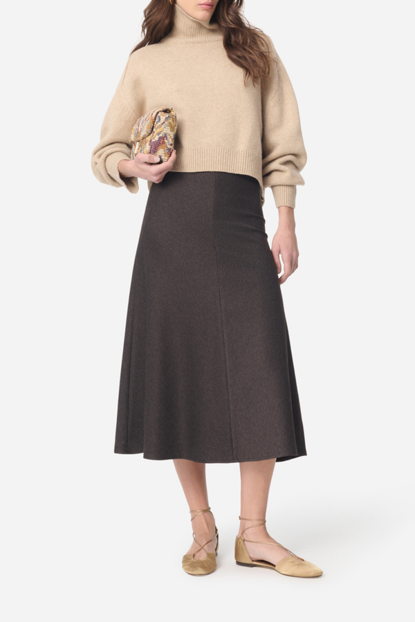front profile model wearing Boushra Midi Skirt brown Midi skirt in flowing crepe
Fitted waist emphasizing the silhouette
Flared cut and light movement
Invisible zipper closure at the back
Mid-calf length
72% Viscose 24% Polyamide 4% Elastane