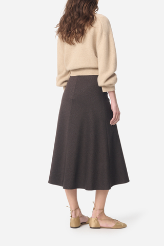 back profile model wearing Boushra Midi Skirt brown Midi skirt in flowing crepe
Fitted waist emphasizing the silhouette
Flared cut and light movement
Invisible zipper closure at the back
Mid-calf length
72% Viscose 24% Polyamide 4% Elastane