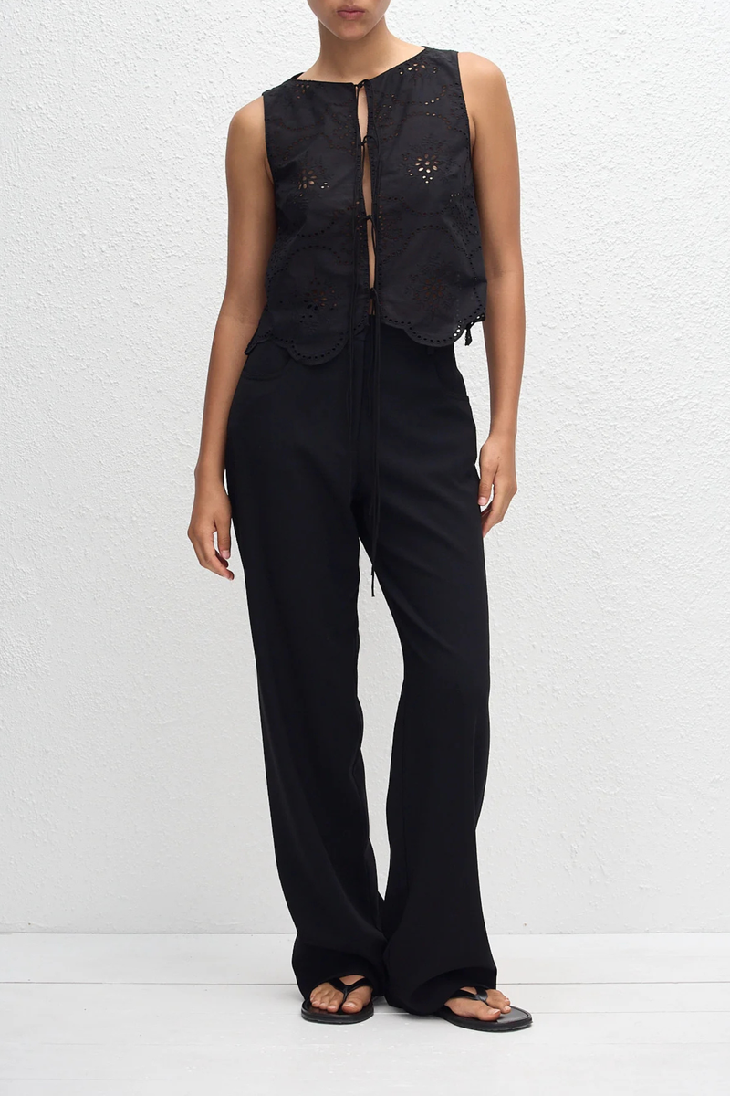 front profile model wearing Broderie Tie Top black Delicate floral broderie
Scalloped hem finish
Open tie front
Sleeveless Blouse
100% Cotton
