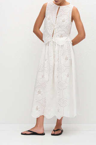 front profile model wearing Broderie Tie Top white Delicate floral broderie
Scalloped hem finish
Open tie front
Sleeveless Blouse
100% Cotton